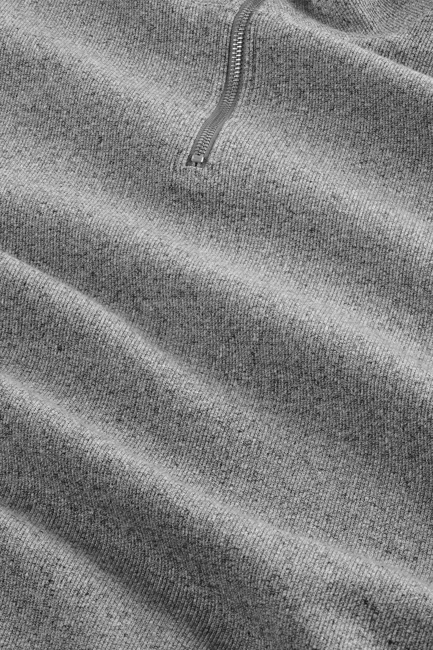 Close-up of gray fleece fabric with a zipper