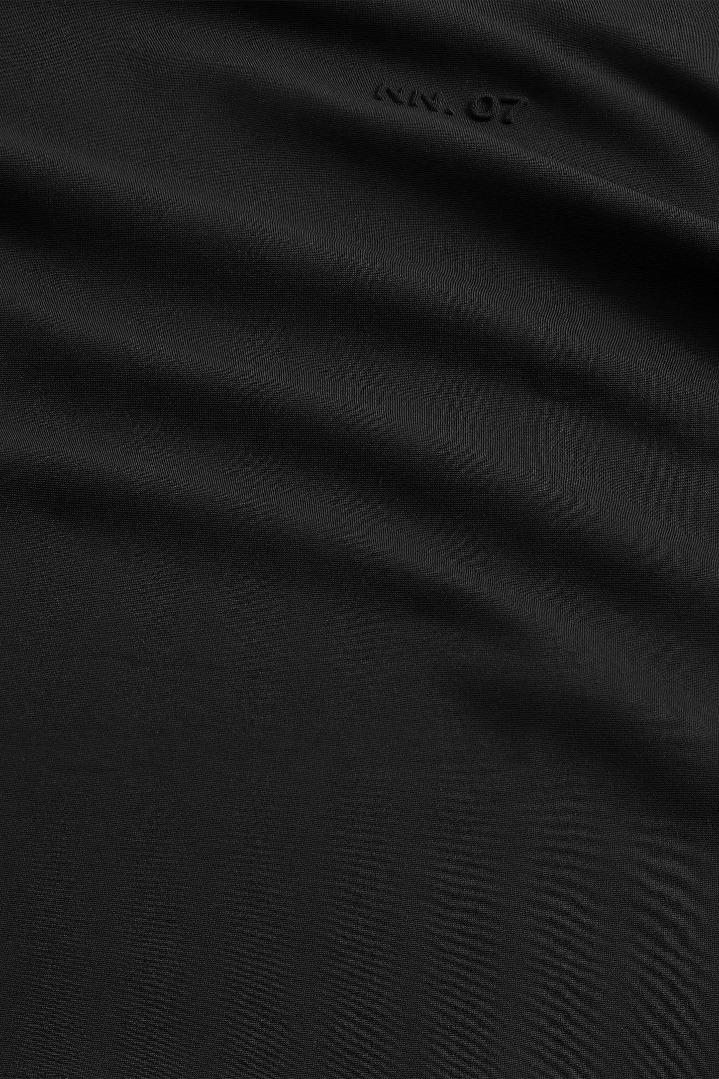 Black fabric with a brand logo in the corner